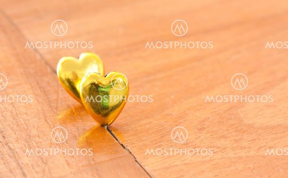 gold hearts on wooden floor