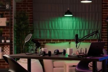 Nobody in cozy ambient room with podcast equipment,...