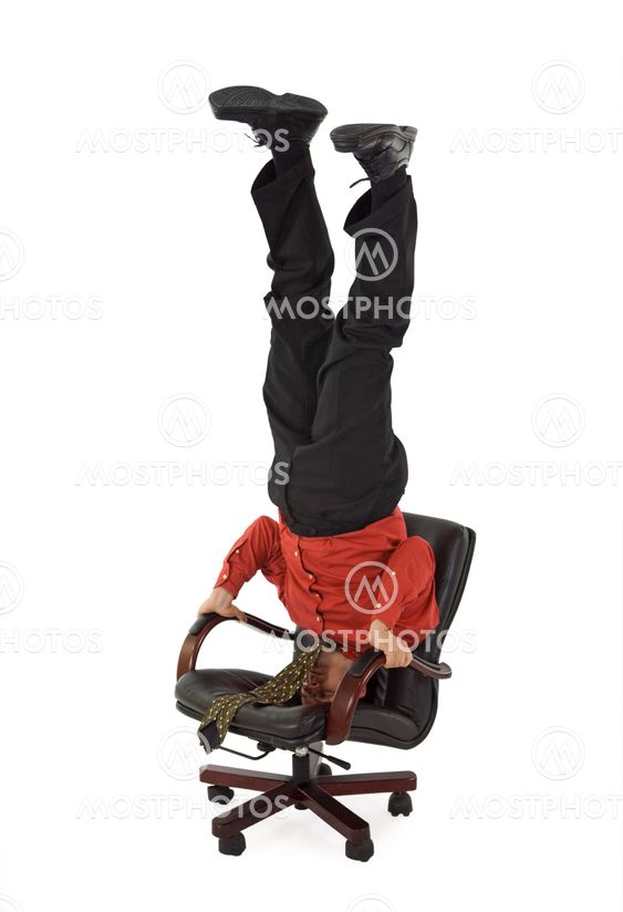 Businessman relaxing on office chair - unusual position