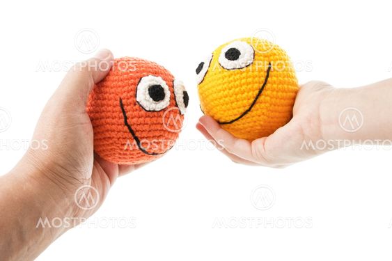 Two smileys in woman and man hands