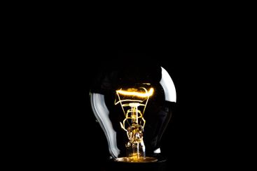 Close-up of electrical bulb on black background