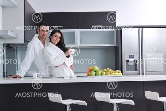 young couple have fun in modern kitchen