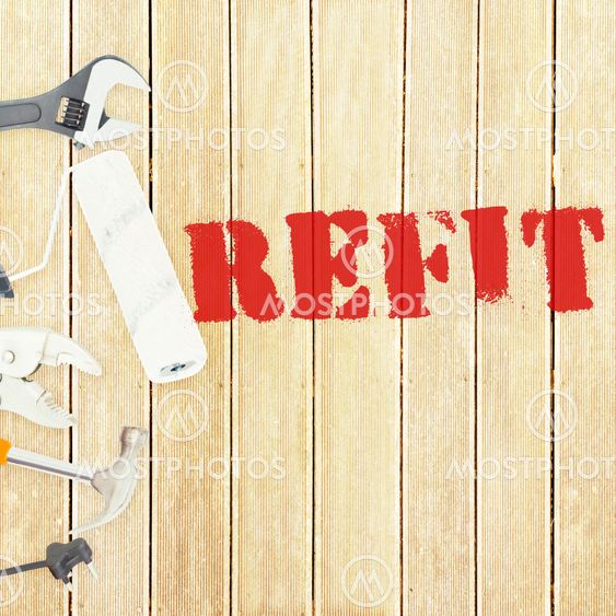 Refit against tools on wooden background