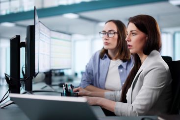 Professional Woman Analyzing Medical Reports On Computer