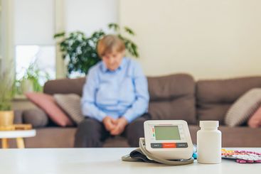 An old woman measures her blood pressure. Selective focus.