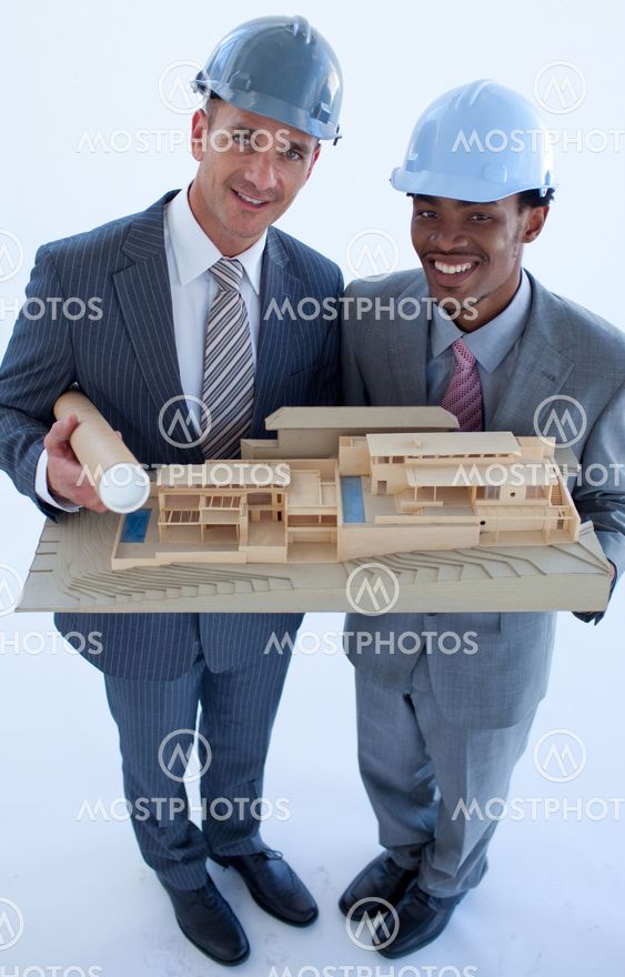 Engineers with hard hats holding a model house