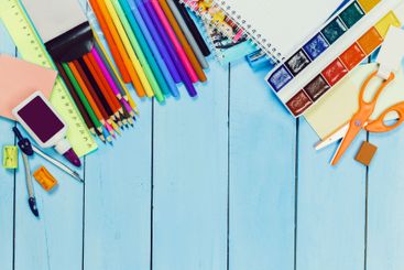 Colorful stationery and art supplies arranged on a...