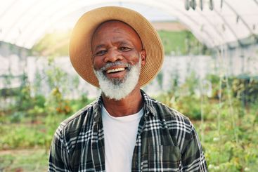 Farm, greenhouse and portrait of mature man with plants...