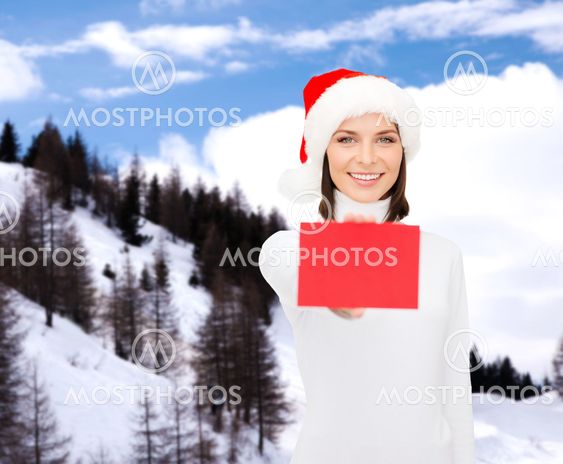woman in santa helper hat with blank red card