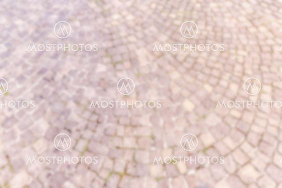 Defocused background of Sampietrini cobblestone pavement in Rome, Italy