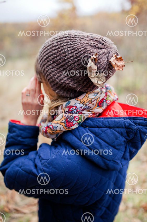 The girl stands with her back.
