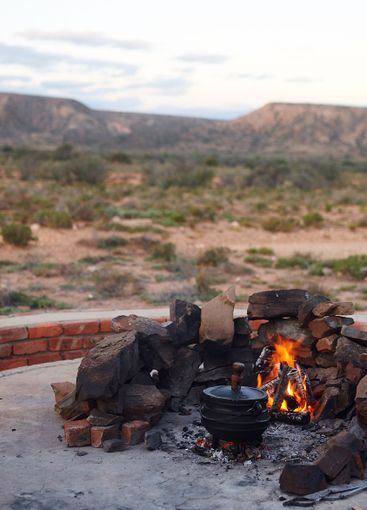 Cast iron pot, campfire and outdoor in nature for...