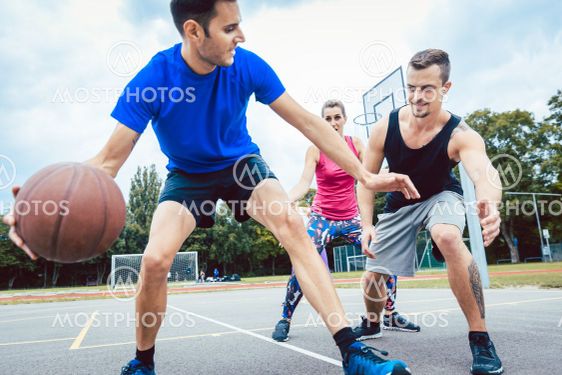 Basketball players practicing game at outdoor