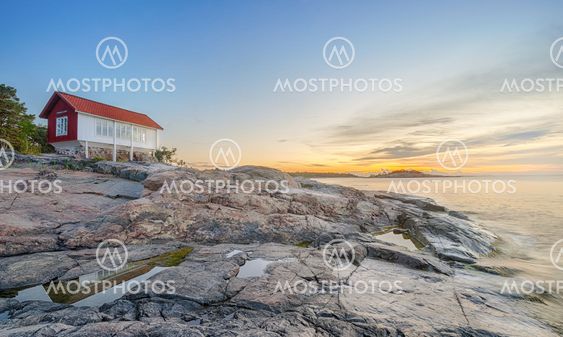 Red house at seafront in morning light