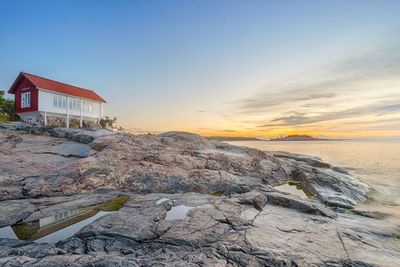 Red house at seafront in morning light