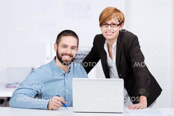 Businessman And Businesswoman With Laptop
