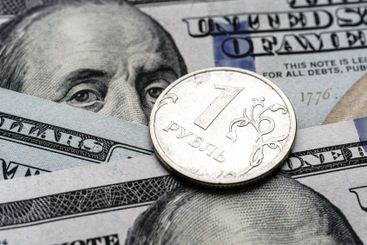 Close-up of 1 Russian rubles coin on US 100 dollar bills...