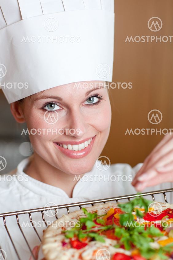 Radiant female chef cooking a pizza