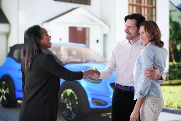 Excited Couple Receives New Car from Sales Agent Together