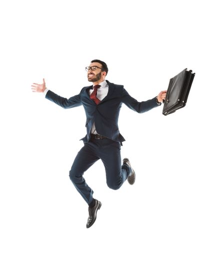 happy businessman with briefcase jumping and smiling...