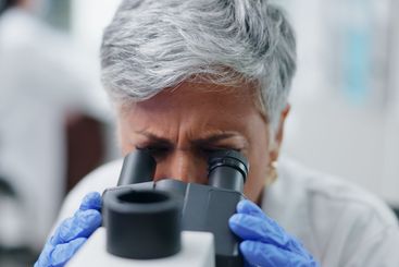 Science, microscope and woman closeup in lab with...