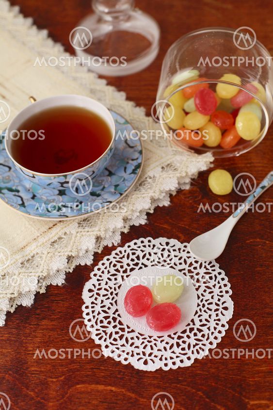 Tea with coloured sugar candies in a glass can