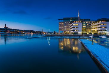 Stunning dusk view of Gothenburg harbor with city...