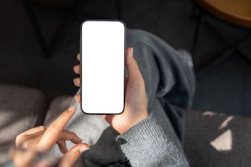Top view of a woman sitting indoors, sunlight streaming...