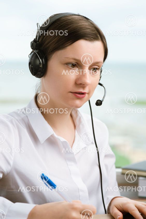 Woman with headset working in office to solve problems