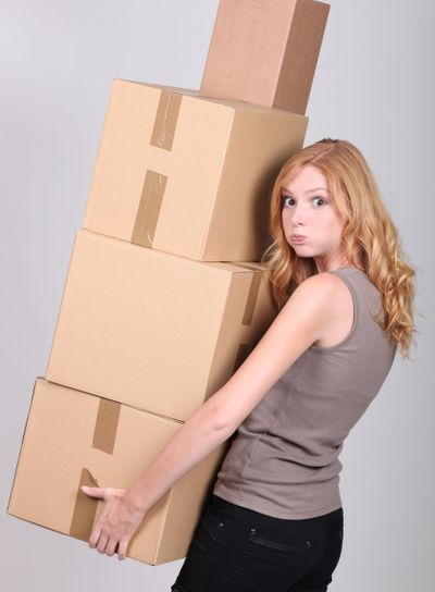 Woman carrying heavy boxes