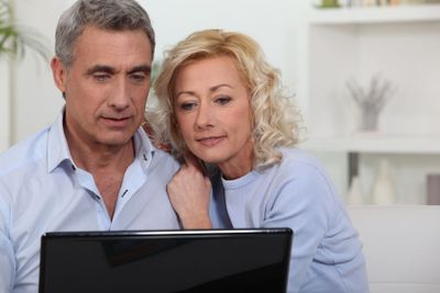 Couple looking at photos on their laptop