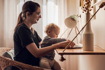 Woman working at home with her baby