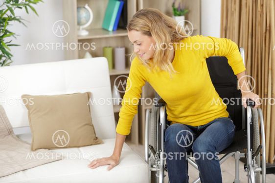young woman in wheelchair at home