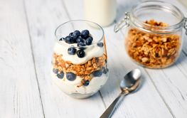 Homemade granola with nuts and fresh blueberries for...