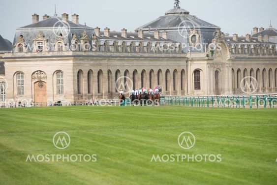 CHATILLY, FRANCE - JUNE 2013: Third Course of the Prize of Diane Longines and Museum of Horse in background on June 16, 2013 in Chantilly. Course name: Grand Handicap Longines.