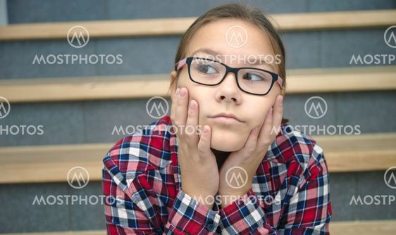 Girl is sitting on stairs and thinking