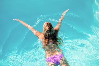 Woman swimming in swimming pool