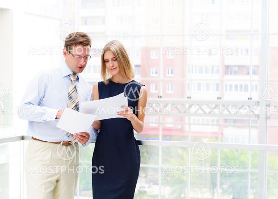 business man and business woman in the office to discuss reports