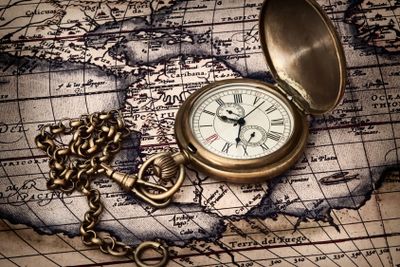 vintage clock at antique map