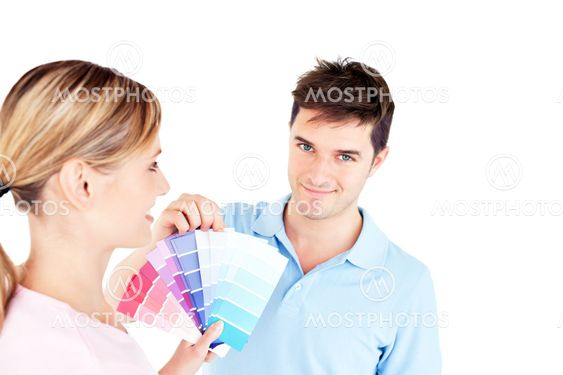 Bright young couple choosing color for a room