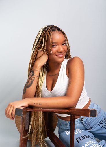 Beautiful brunette woman with braids in her hair,...