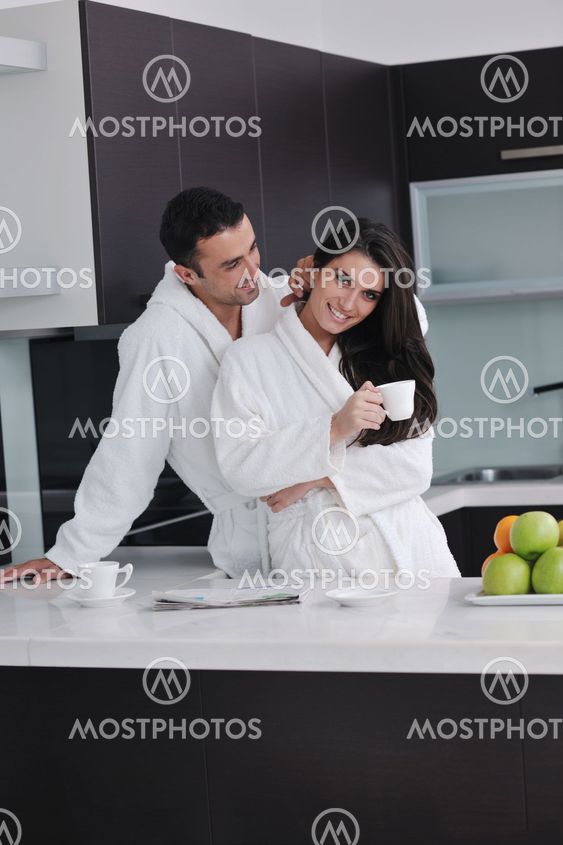 young couple have fun in modern kitchen