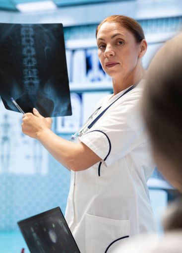 Doctor showing the x ray scan results to her colleagues...