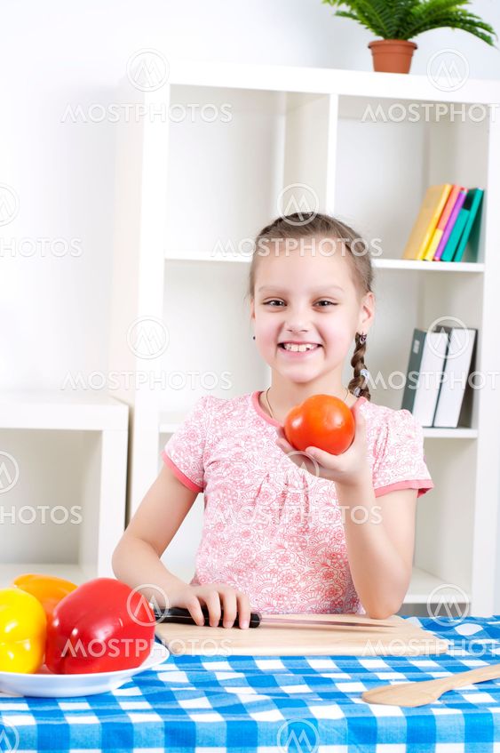 girl working in the kitchen cutting vegetables