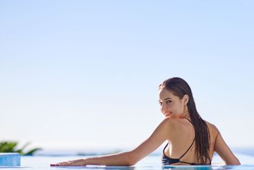 Woman, happy and portrait in swimming pool with sky,...
