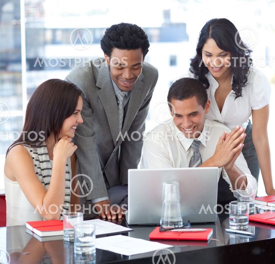 Multi-ethnic business team working together with a laptop