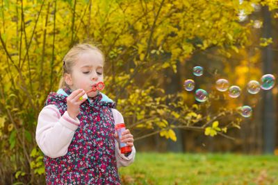 Blowing soap bubbles