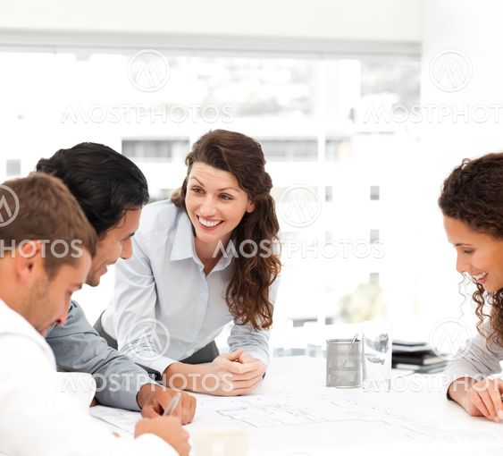 Happy female architect with her team during a meeting