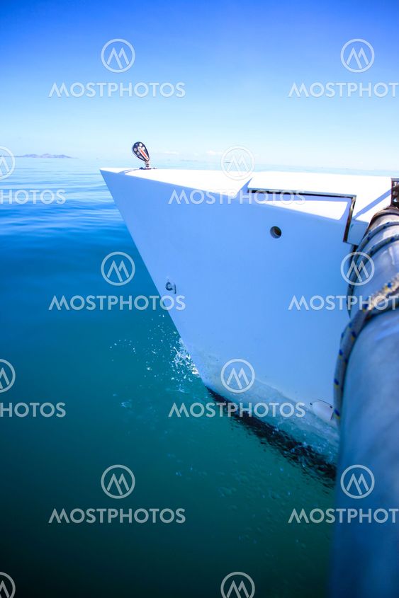 Bow of a sailing boat in calm blue sea