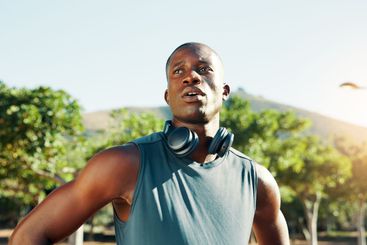 Outdoor, black man and tired with thinking for fitness,...